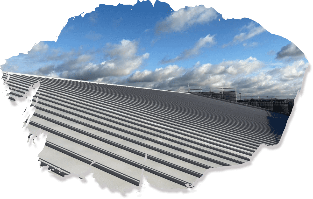 広大なシルバーの金属屋根、遠くに工事用足場